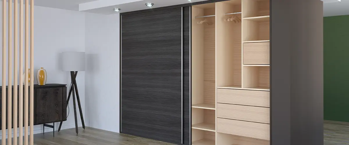 Modern built-in wardrobe with open shelving and sliding doors in a contemporary minimalist bedroom.