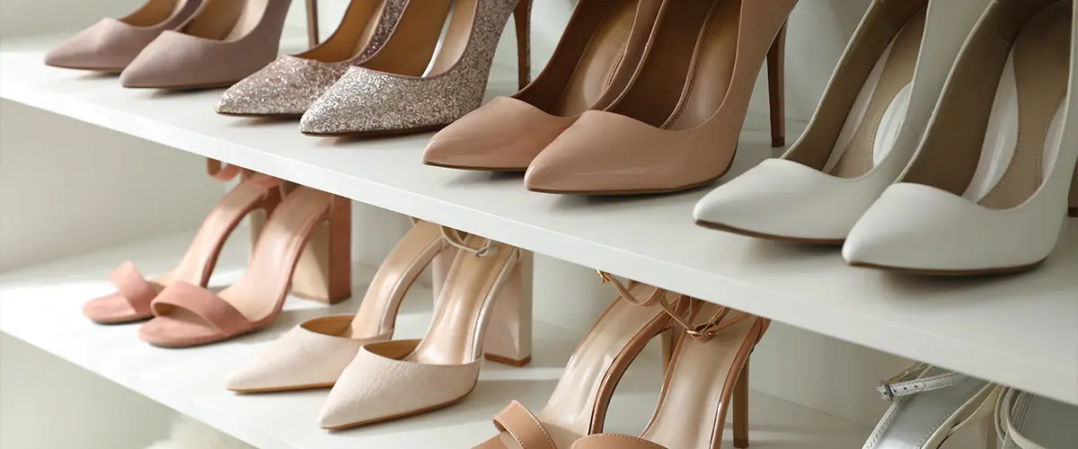 Organized shoe shelf displaying a collection of elegant high heels and sandals - luxury footwear storage and closet organization.