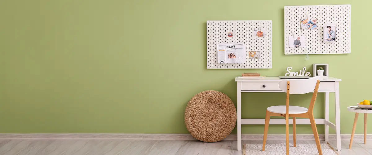 pegboard organizer in small office witg green wall