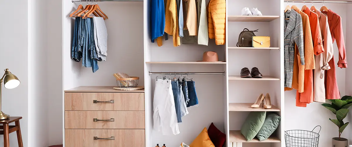 Organized modern wardrobe with clothes, shoes, and accessories neatly arranged, ideal for home closet organization and storage solutions.