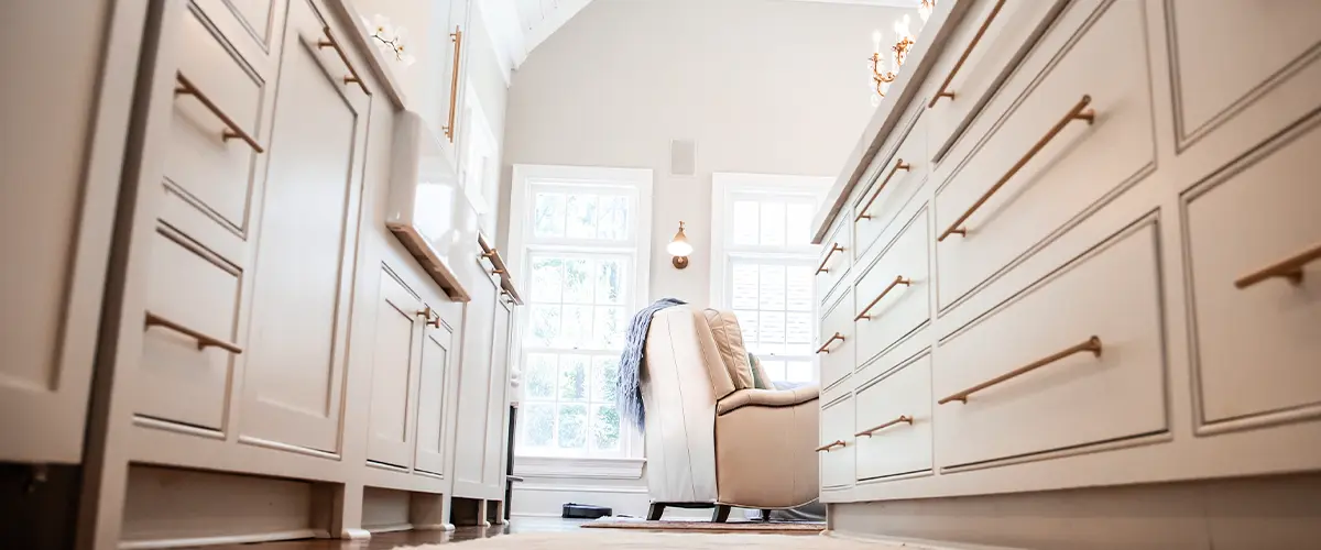 Luxury kitchen with cream cabinetry, large island, and vaulted ceiling with natural light