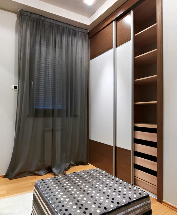 Modern bedroom wardrobe with sliding doors and shelves