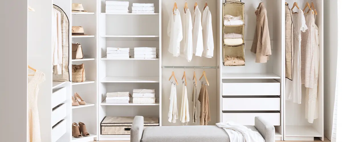 Beautifully organized closet with hanging clothes, baskets, and storage compartments for minimalist and functional living.